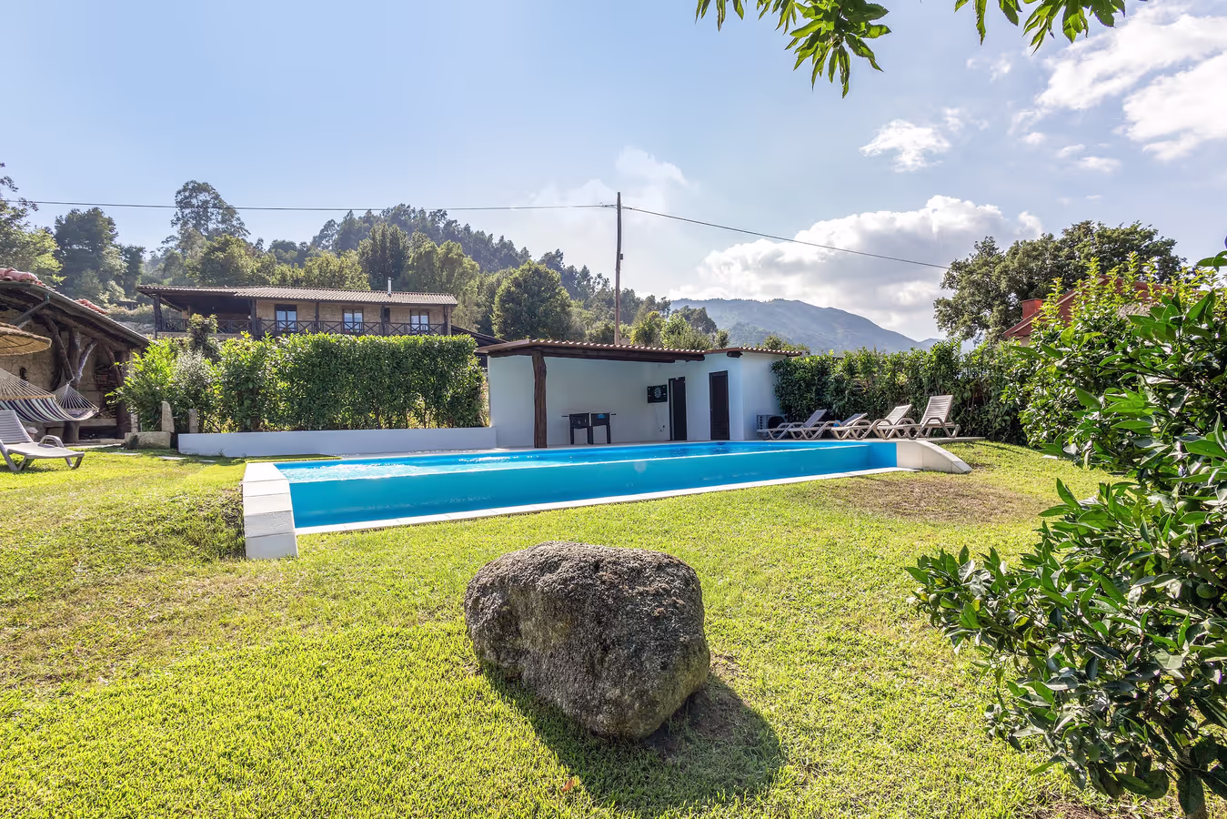 A piscina vista do jardim